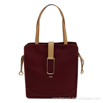 Big shopper bag with one middle zip compartment and one big decoration buckle on front tab